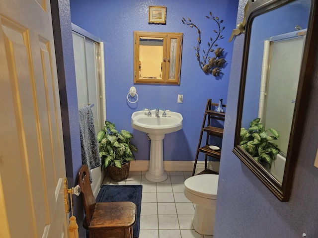 bathroom with toilet and tile patterned flooring