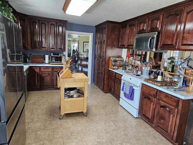 kitchen featuring electric stove, dark brown cabinets, and a textured ceiling