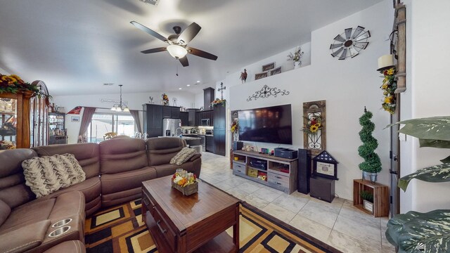 tiled living room with ceiling fan and vaulted ceiling