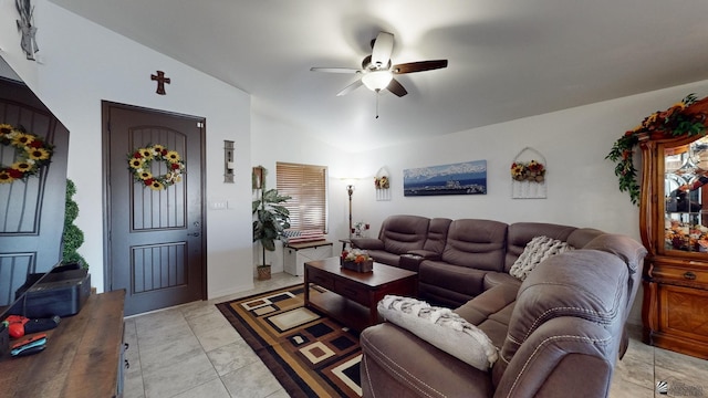 tiled living room with ceiling fan and lofted ceiling