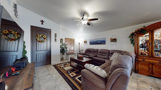 living room featuring ceiling fan, light tile patterned flooring, and lofted ceiling