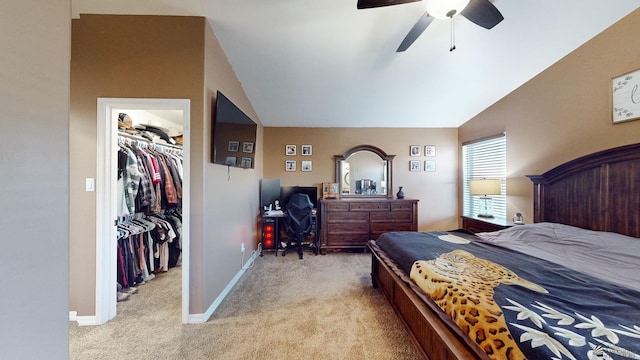 carpeted bedroom featuring ceiling fan, a spacious closet, a closet, and vaulted ceiling