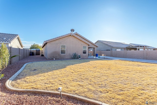 rear view of house with a yard