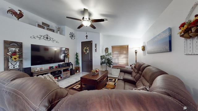 tiled living room featuring ceiling fan and lofted ceiling