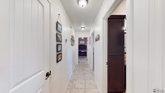 hall with light tile patterned floors