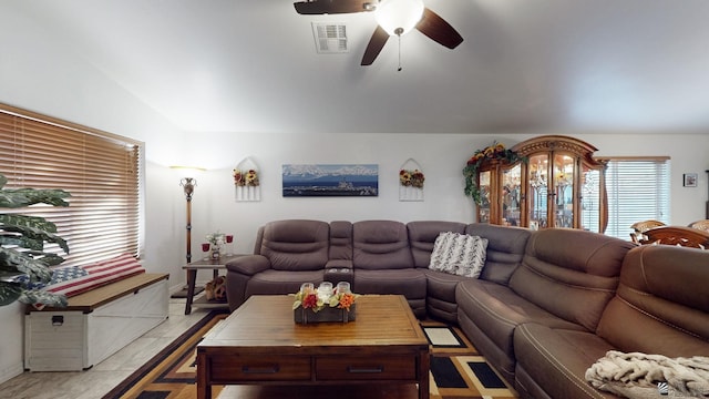 living room with ceiling fan and vaulted ceiling