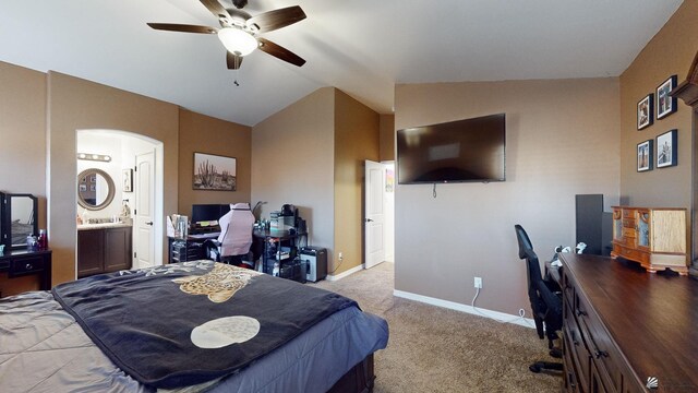 bedroom featuring ceiling fan, light colored carpet, connected bathroom, and lofted ceiling