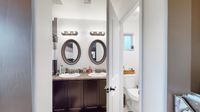 bathroom with toilet and vanity