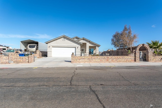 view of front of property with driveway, an attached garage, fence, a carport, and stucco siding