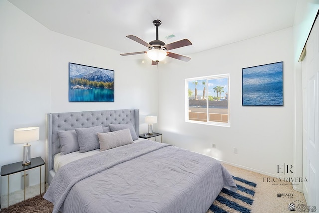 carpeted bedroom with a ceiling fan, baseboards, and visible vents