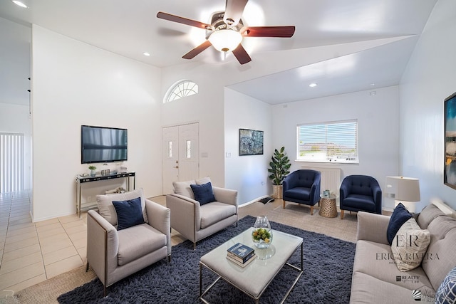 living area with tile patterned flooring, plenty of natural light, recessed lighting, and vaulted ceiling