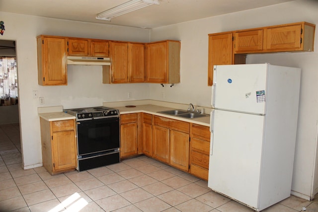 kitchen with white fridge, light tile patterned flooring, black range with electric stovetop, and sink