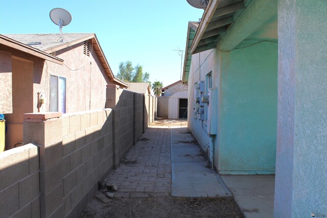 view of side of property with a patio and a shed