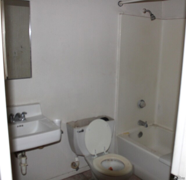 full bathroom with sink, bathtub / shower combination, and toilet