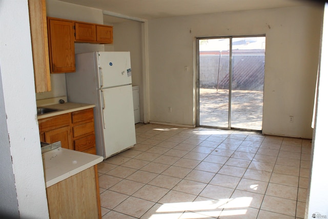 kitchen featuring white refrigerator and light tile patterned floors