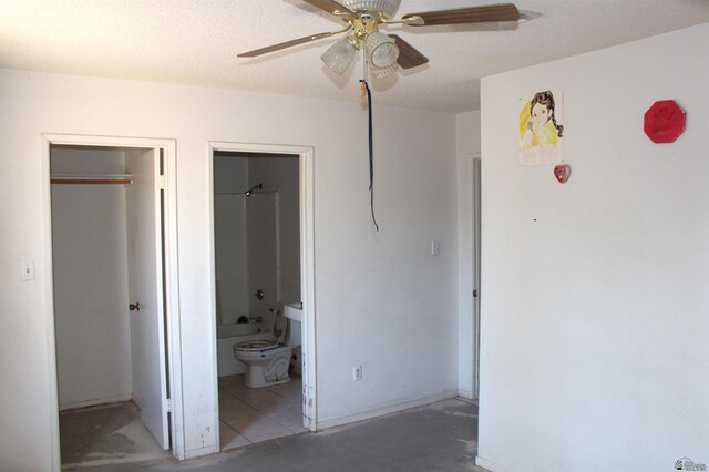 unfurnished bedroom featuring ensuite bathroom and ceiling fan