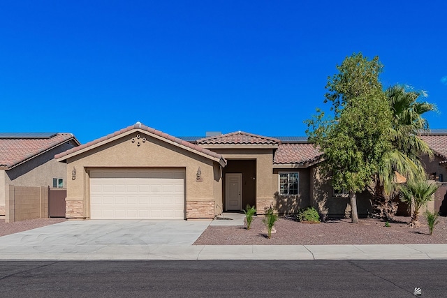 view of front of home featuring solar panels and a garage