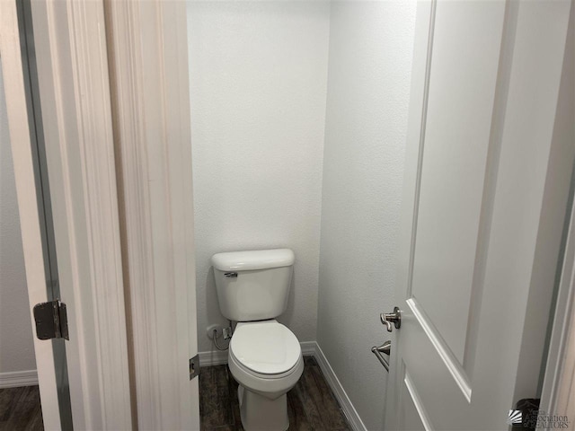 bathroom with wood-type flooring and toilet