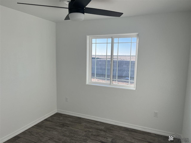 unfurnished room featuring dark wood-type flooring and ceiling fan