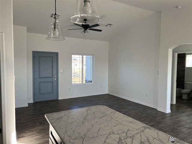 foyer featuring dark hardwood / wood-style flooring, vaulted ceiling, and ceiling fan