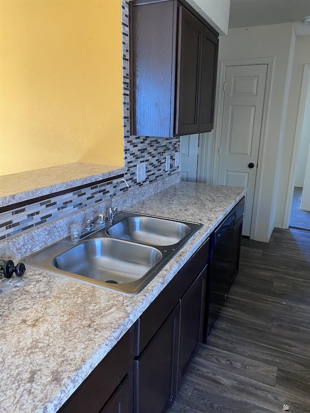 kitchen featuring sink, dark hardwood / wood-style floors, black dishwasher, tasteful backsplash, and dark brown cabinets