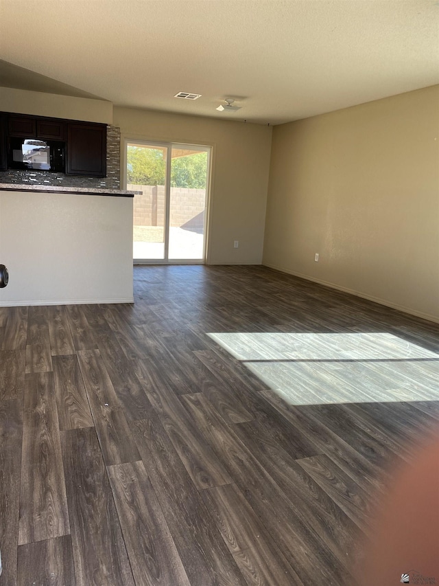 unfurnished living room with dark hardwood / wood-style floors