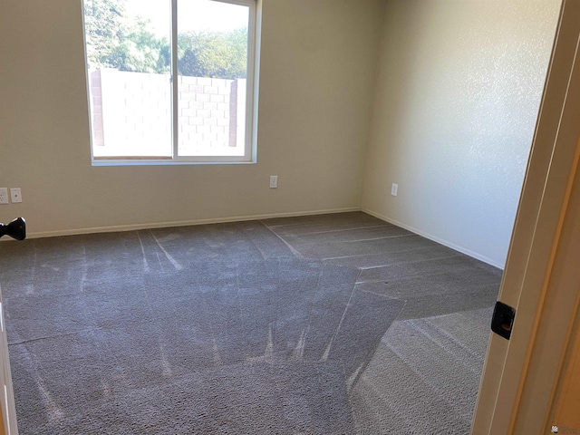 carpeted spare room with a healthy amount of sunlight