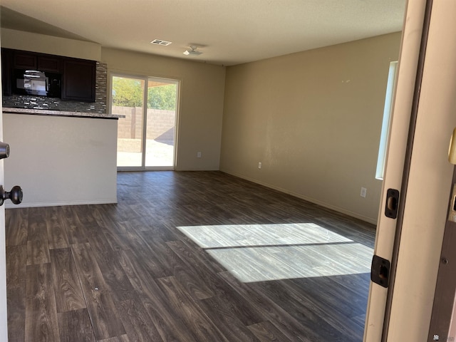 unfurnished living room featuring dark hardwood / wood-style floors