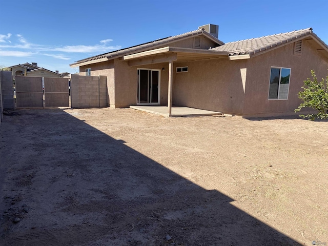 back of house with central air condition unit and a patio