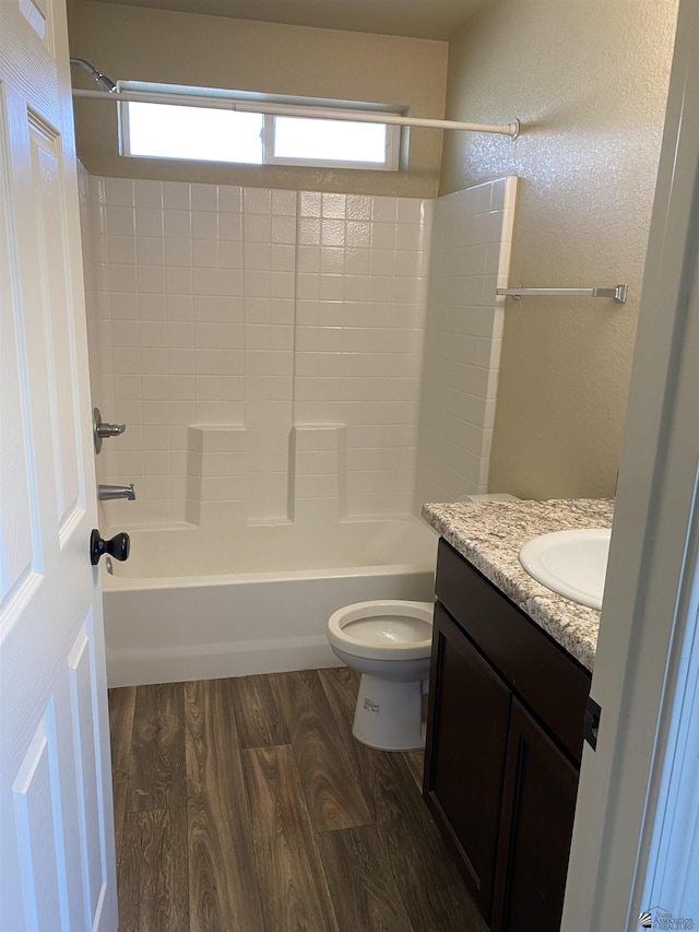 full bathroom featuring wood-type flooring, vanity, toilet, and shower / bathtub combination