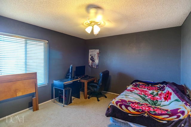 bedroom featuring carpet, a textured ceiling, and ceiling fan