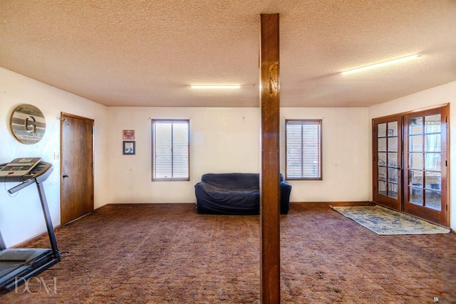 interior space featuring french doors, a textured ceiling, and a healthy amount of sunlight