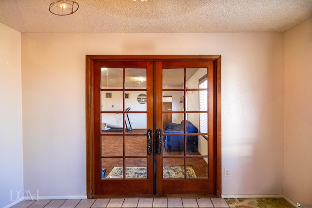 doorway with a textured ceiling and french doors