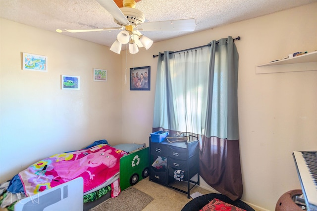 bedroom with carpet, a textured ceiling, and ceiling fan