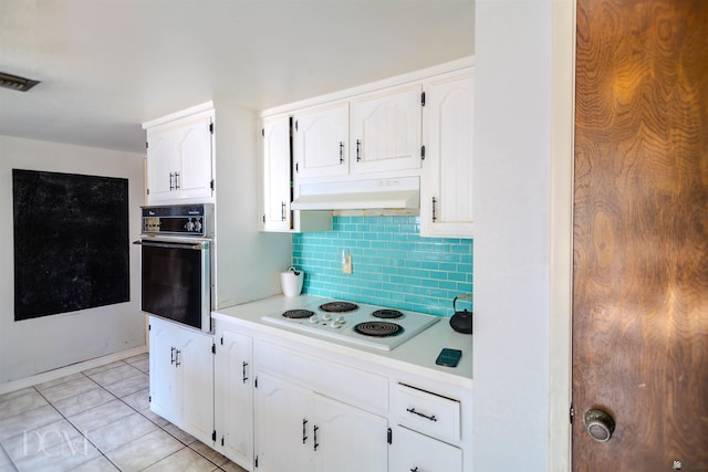 kitchen with white cabinetry, wall oven, white electric stovetop, decorative backsplash, and light tile patterned floors