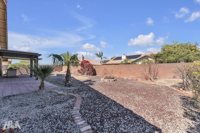 view of yard featuring an outdoor fire pit, a fenced backyard, a deck, and a pergola