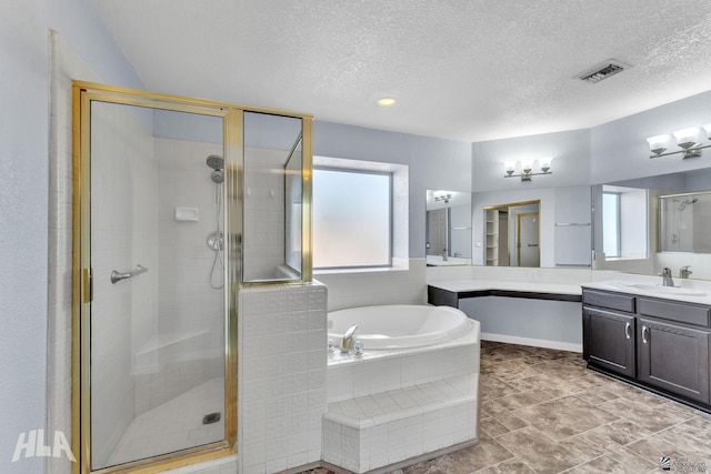 full bath with a textured ceiling, a garden tub, vanity, visible vents, and a stall shower