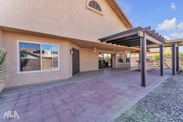 view of patio / terrace with ceiling fan and a pergola