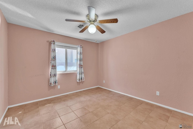 empty room with visible vents, ceiling fan, and baseboards