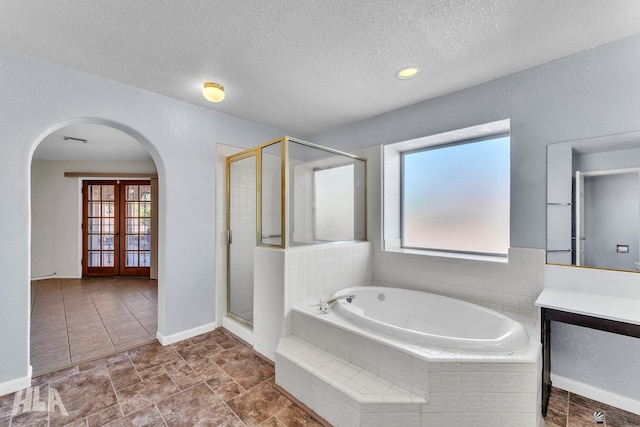 full bath with a stall shower, visible vents, a textured ceiling, vanity, and a bath