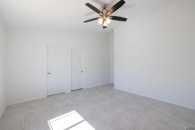 unfurnished room featuring ceiling fan and vaulted ceiling