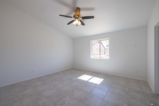 spare room with ceiling fan and light tile patterned floors