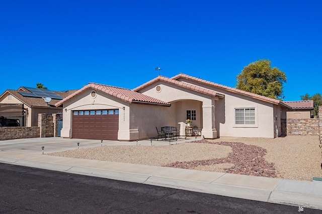 view of front of home with a garage and solar panels