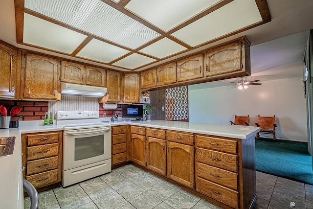 kitchen featuring white range with electric stovetop, brown cabinets, under cabinet range hood, and a peninsula