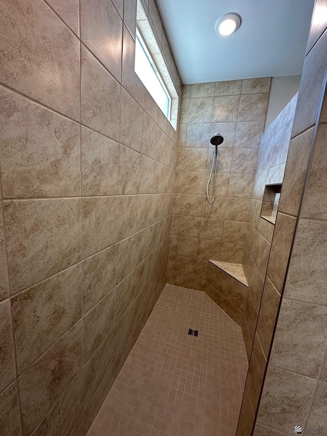 bathroom with tiled shower