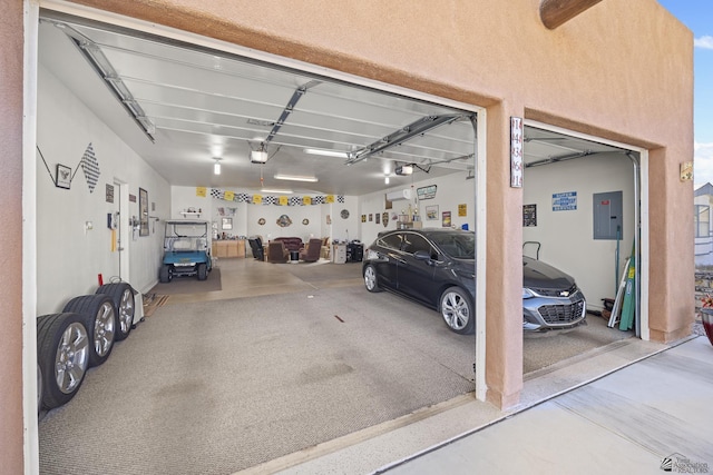 garage featuring electric panel and a garage door opener