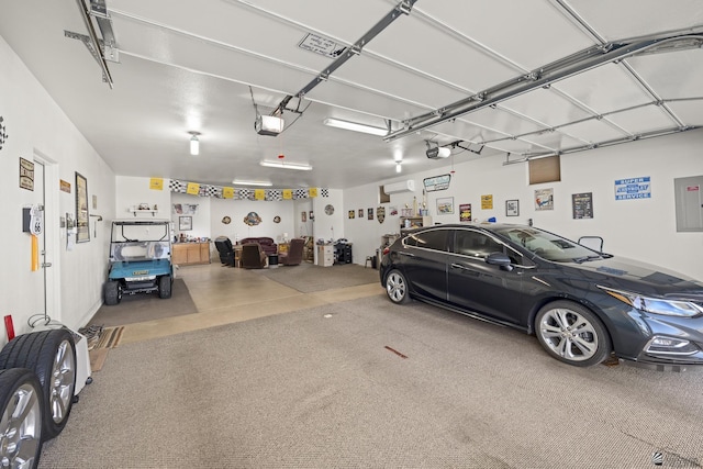 garage featuring electric panel and a garage door opener