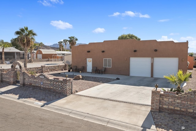 pueblo revival-style home featuring a patio area