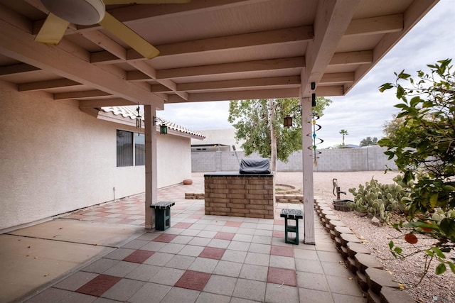 view of patio featuring ceiling fan and a bar