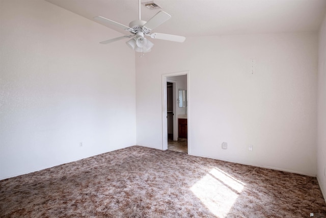 carpeted empty room featuring ceiling fan and lofted ceiling